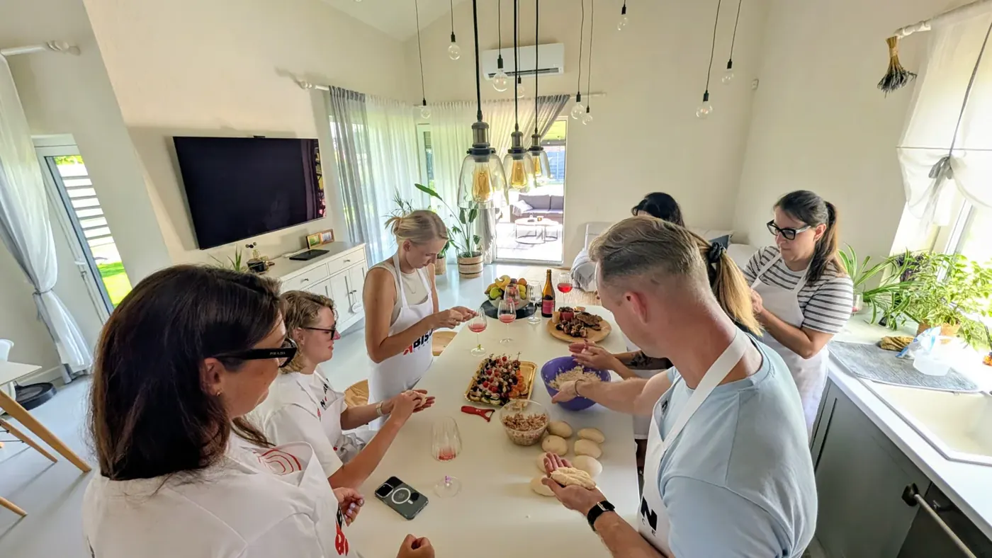 The team around a kitchen island shaping dough at a Bison cooking evening