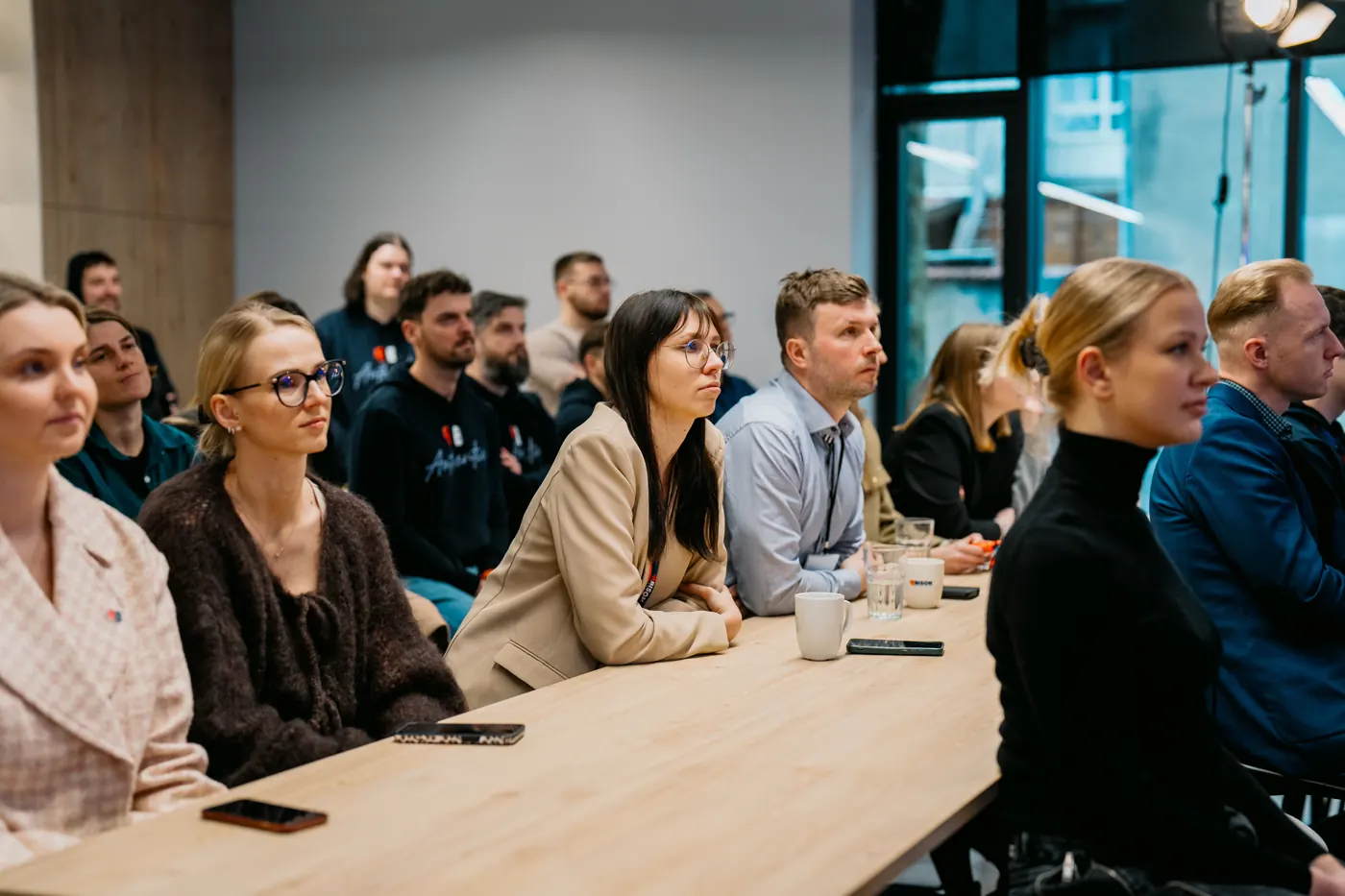 Teammates listening in at a session in the Kaunas office
