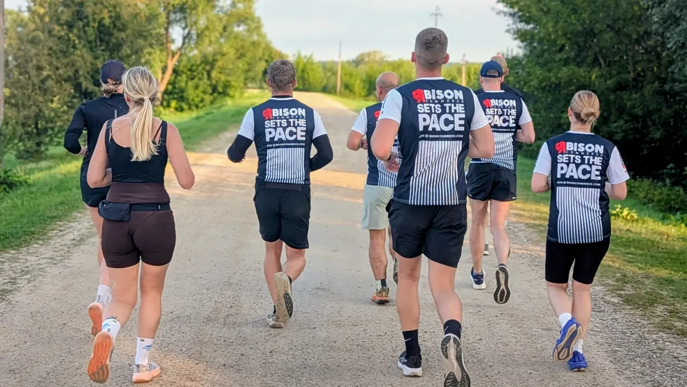 Bison teammates running a country road in Bison Sets the Pace shirts
