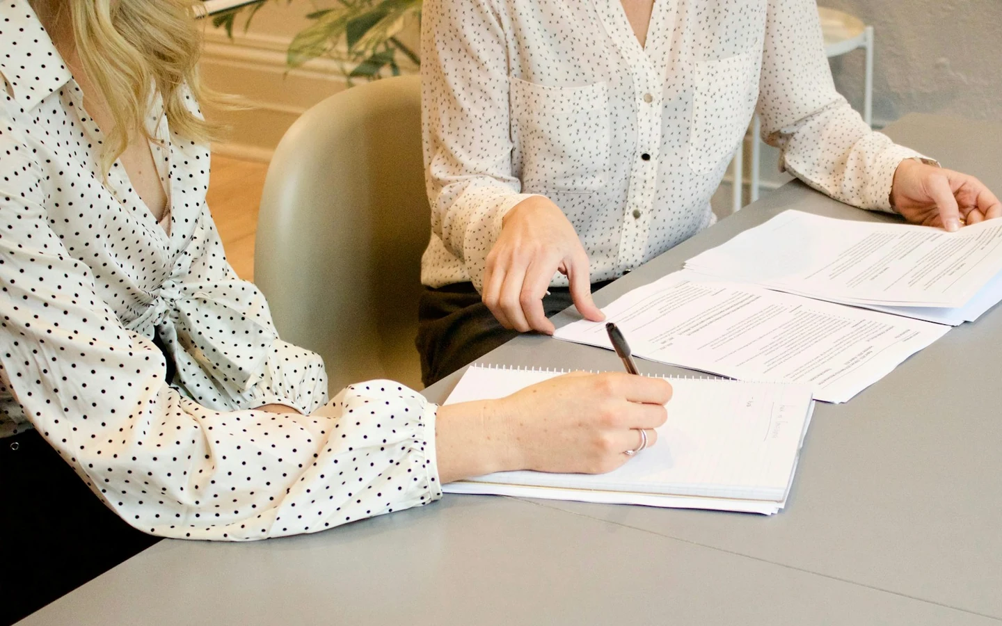 Two people reviewing listing compliance documents and product certificates