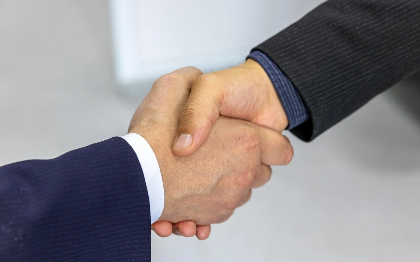 Two partners shaking hands on a marketplace agreement